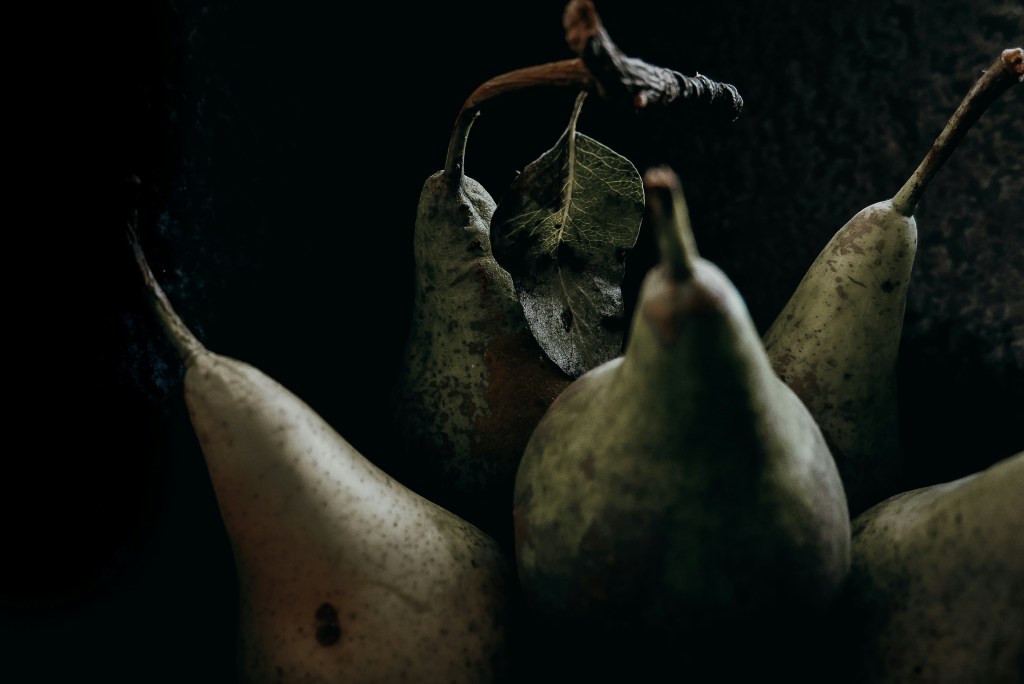 Photo by Anais Murith. Dark and moody close up of pears.