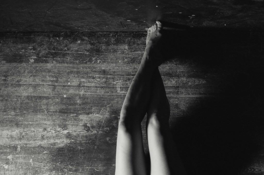 Black and white photo by Velizar Ivanov. Women's bare legs and feet. Artistic photography.