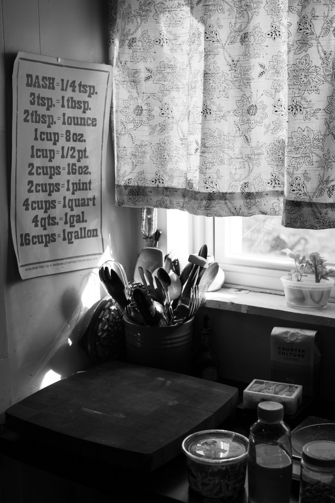 Old fashioned 1950s farmhouse kitchen. Black and white photography.
