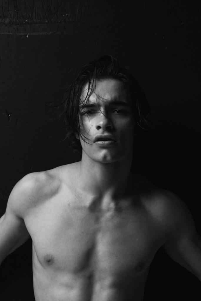 Photo Nikita Skripnik. Black and white artistic photography. Shirtless dark haired young man.