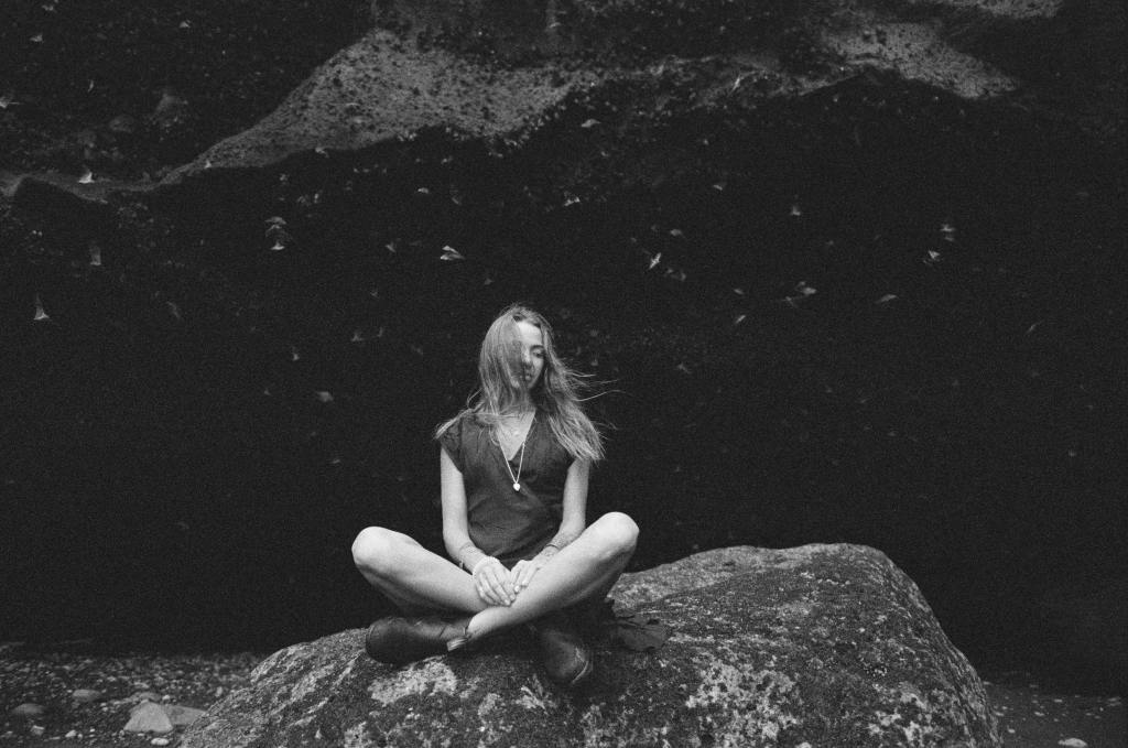 Photo Vladimir Konoplev. Girl sitting on rock in Mexico during Monarch butterfly migration. Black and white photography.